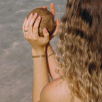 Person holding a coconut on a beach