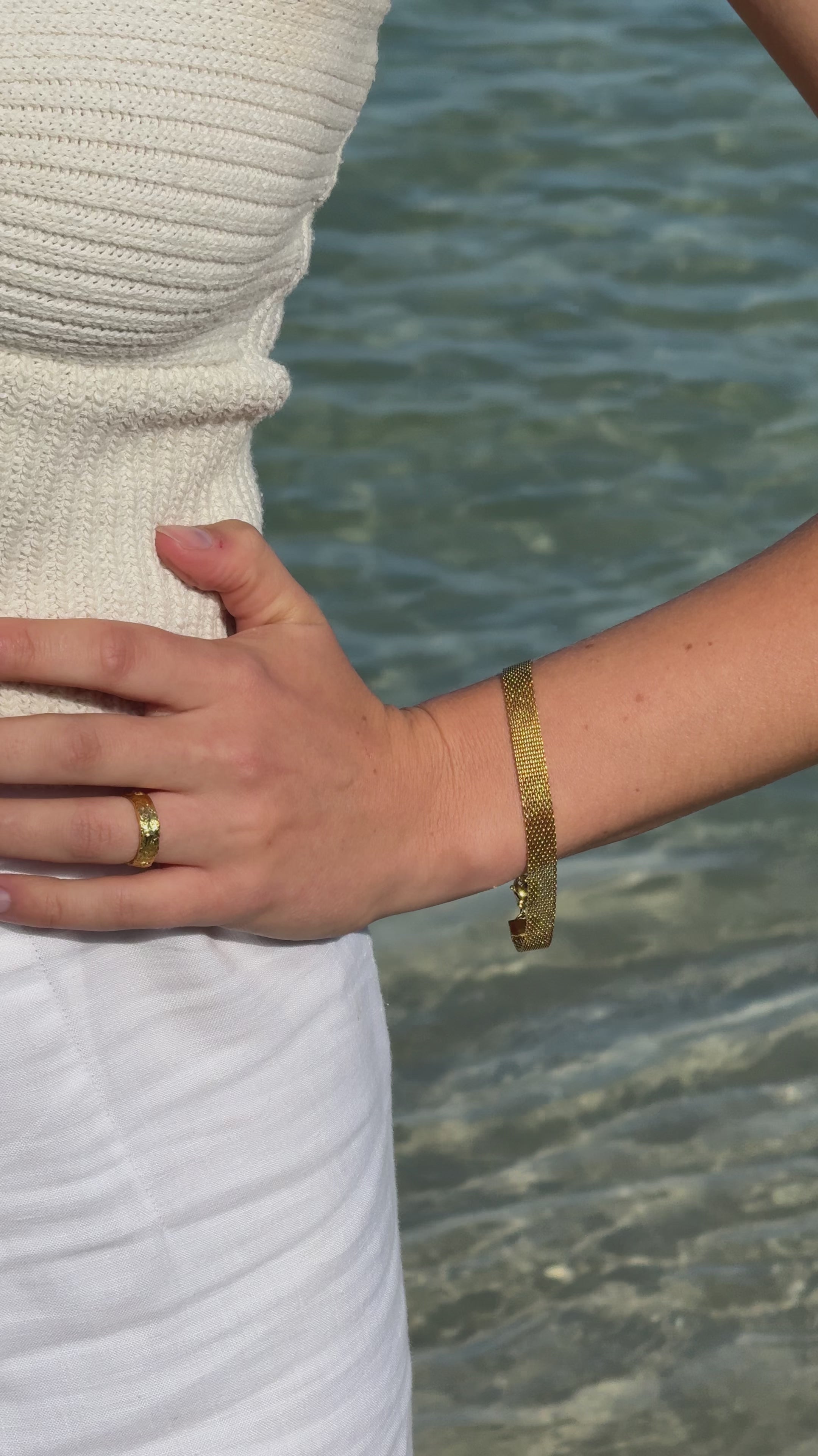 Chain bracelet being worn on beach